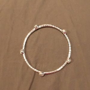 Silver bracelet with white crystals.